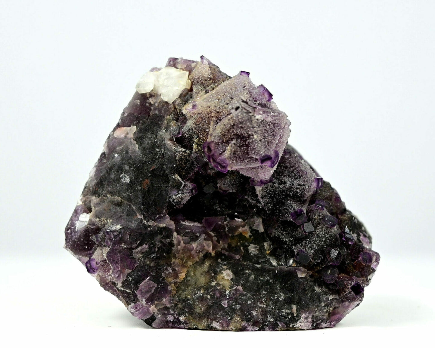 Unusual complete purple fluorite with multiple generation sugar drazy covered and some calcite front