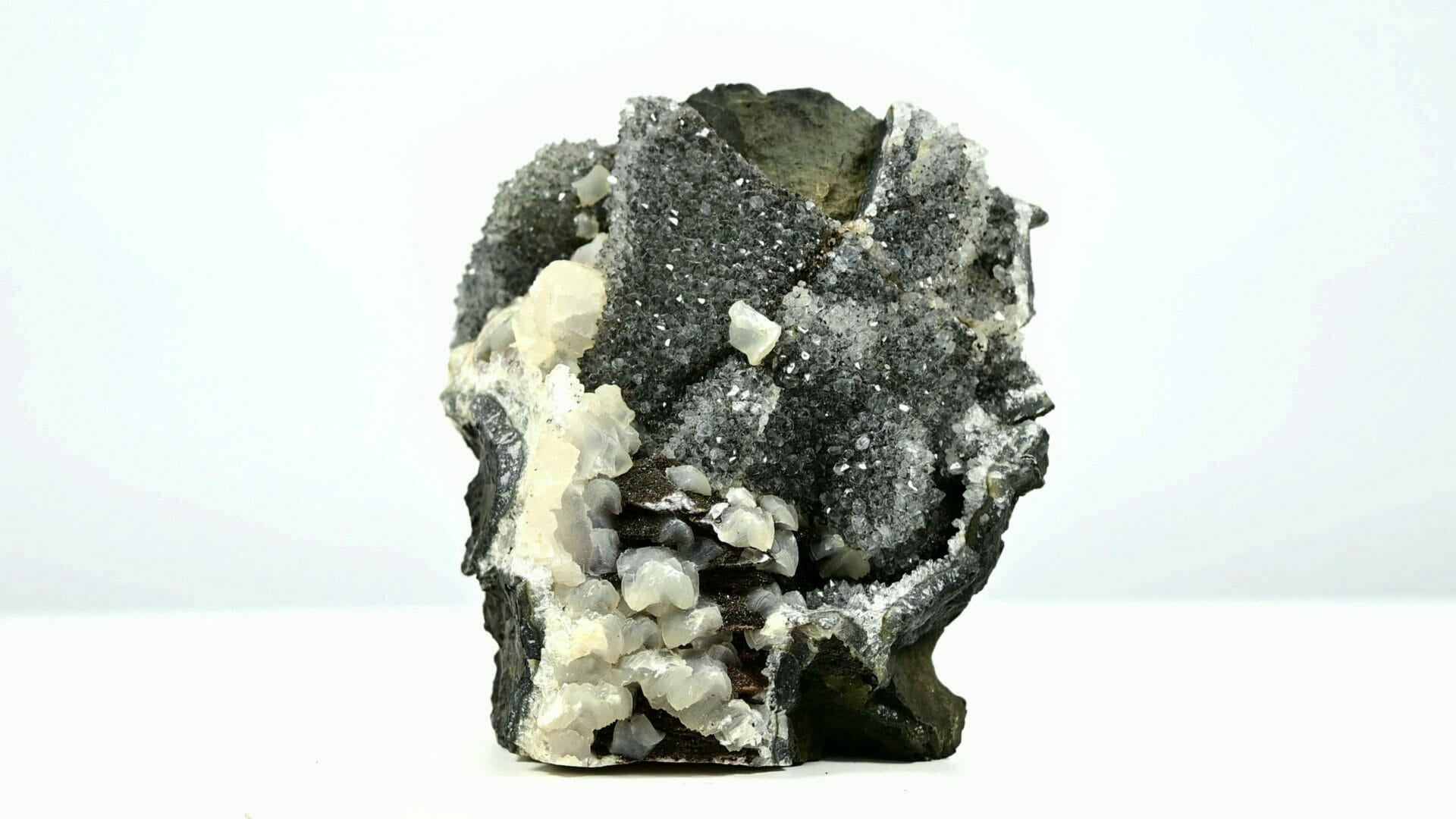 Black druzy crystals with multiple calcite formations and second generations front