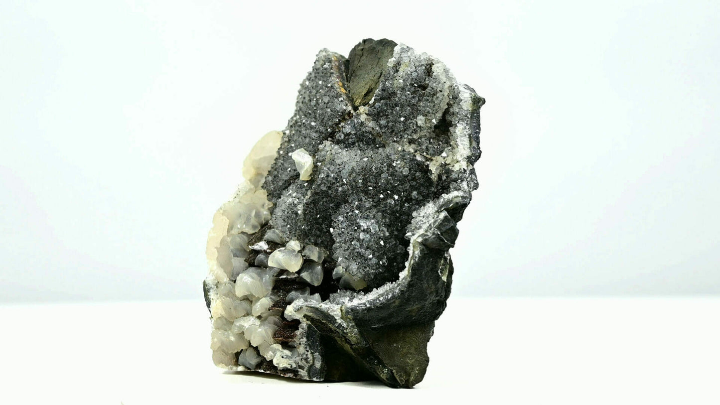 Black druzy crystals with multiple calcite formations and second generations side 2