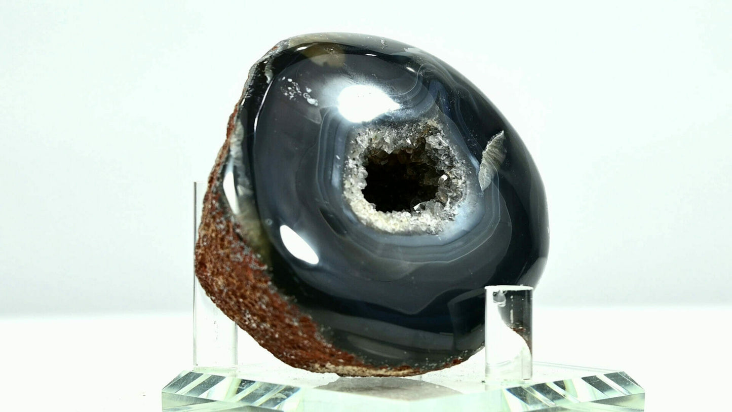 Black rounded agate eye with white light go through it side 1