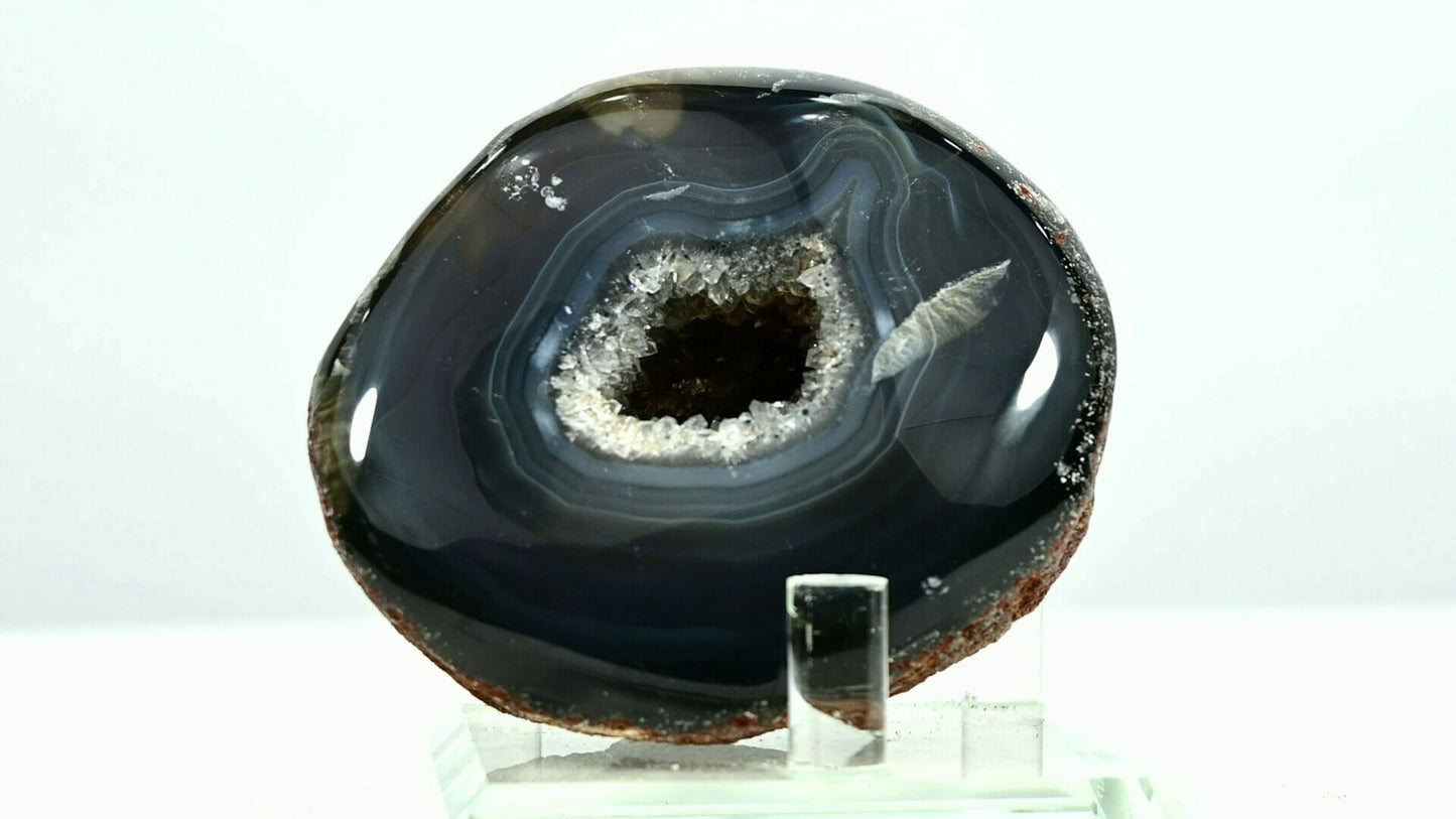 Black rounded agate eye with white light go through it front