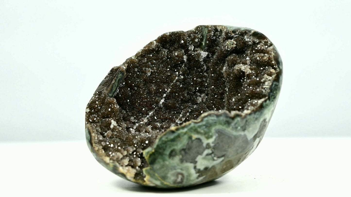 Super bling brown sugar druzy geode bowl with some belts and tiny trees inside side 1
