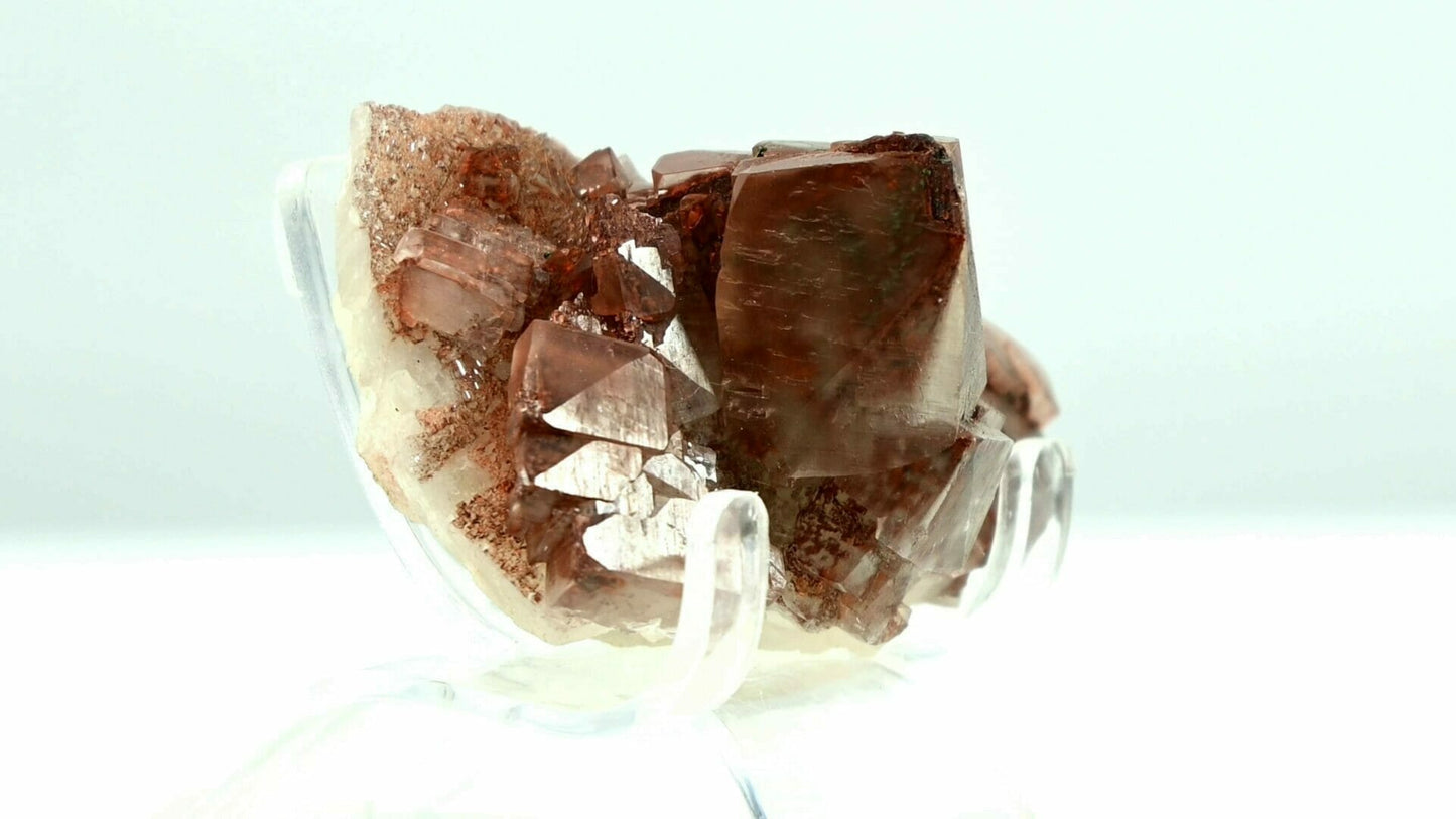 Multiple generational red and transparent calcite with red and black crystal inside. side