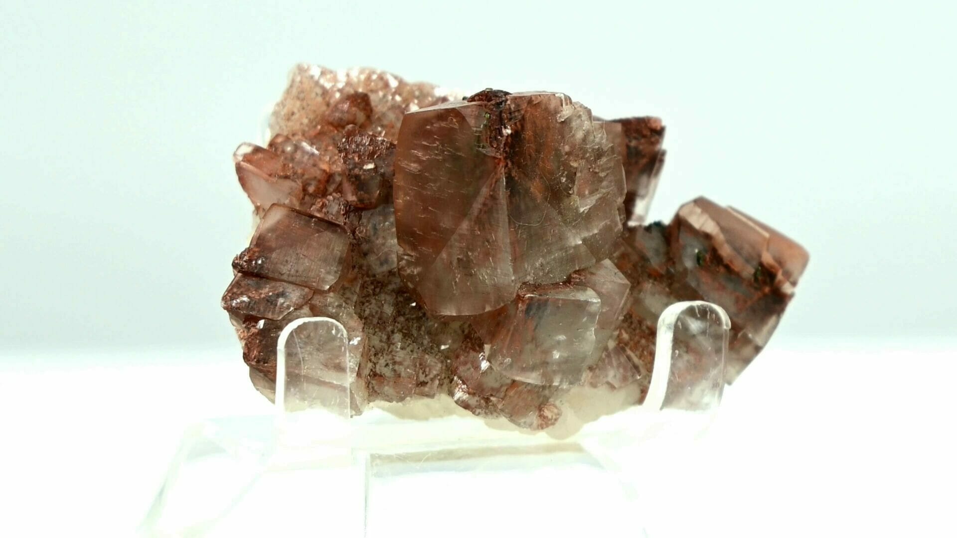 Multiple generational red and transparent calcite with red and black crystal inside. front